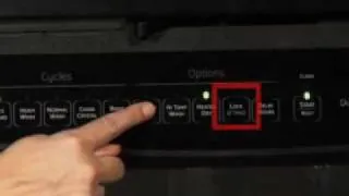 Dishwasher door open with owner's manual and flashlight ready for unlocking