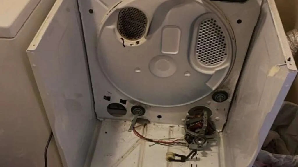 Dryer pulled out with back panel open showing belt and drum