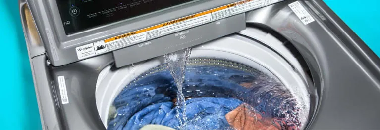 Front-loading washing machine drum with shallow water and clothes inside
