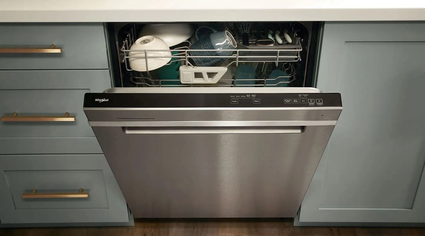 Hand selecting a wash cycle on a dishwasher control panel