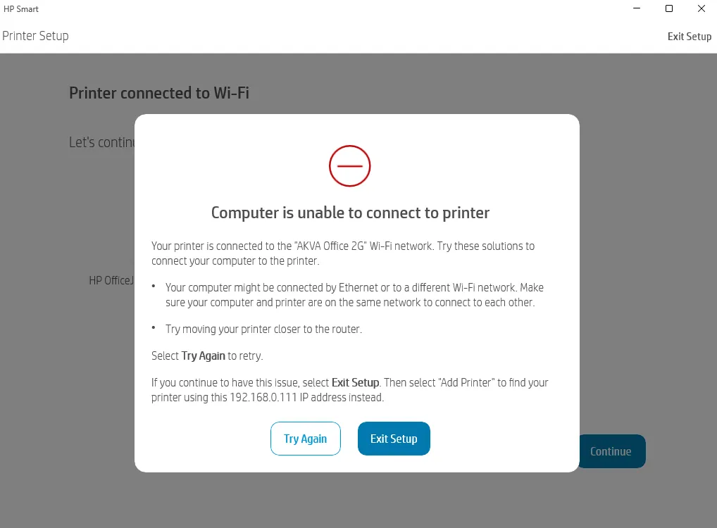 Hands typing on a laptop beside a router to set a fixed printer address