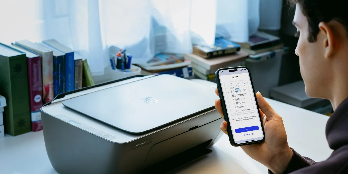 HP printer and laptop on a desk with a router, showing a broken connection
