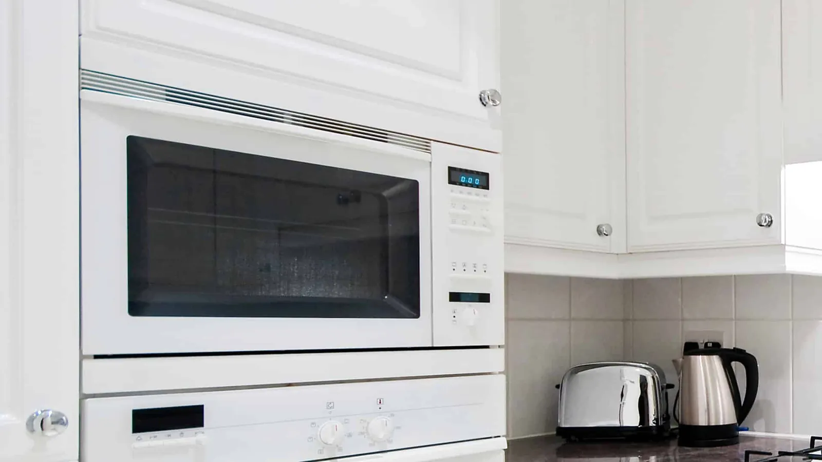 Microwave touch panel showing an error code under a hovering finger