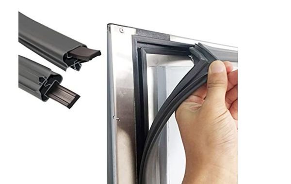 Open freezer door with rubber gasket and towel for remagnetize freezer door seal