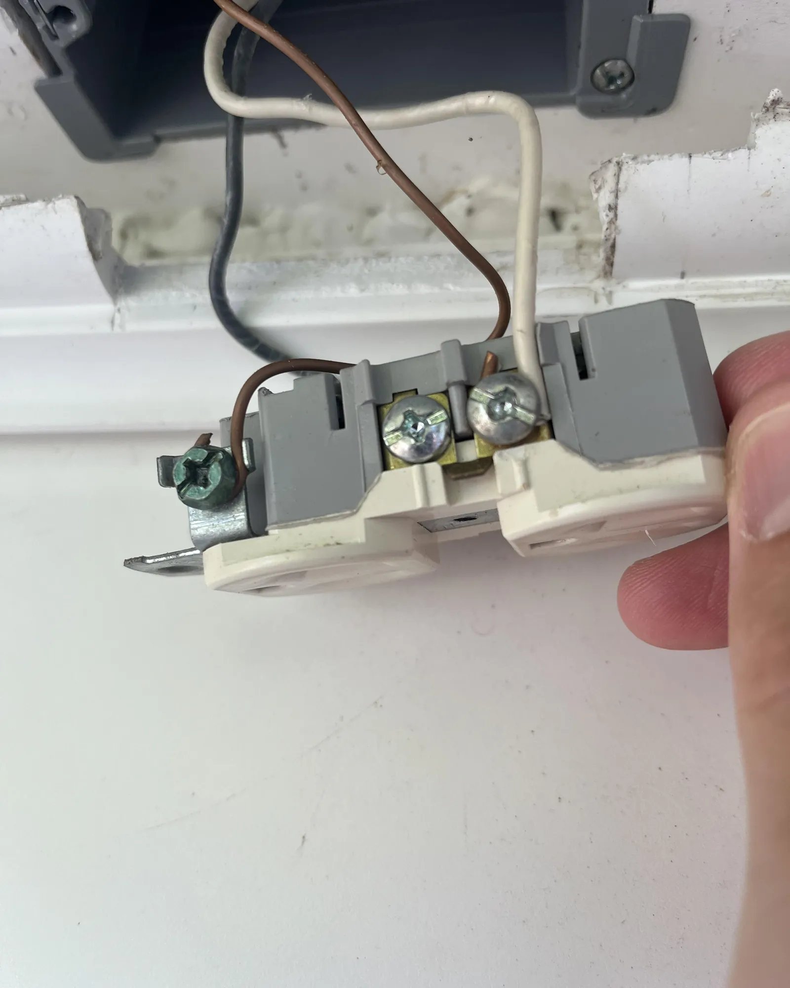 Outdoor outlet with in-use cover protecting a plugged extension cord