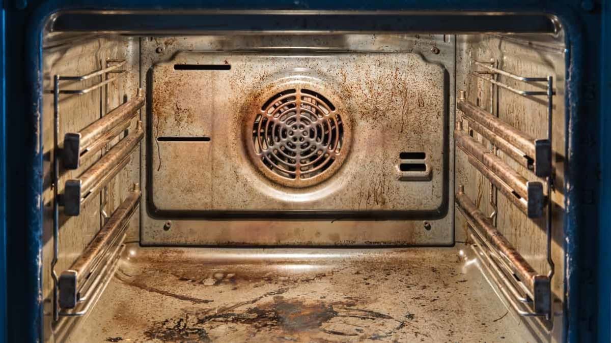 Self-cleaning oven glowing in a dark kitchen at night