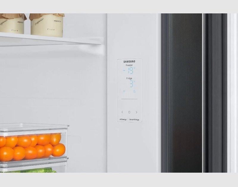 Stainless steel Samsung refrigerator control panel in a bright modern kitchen