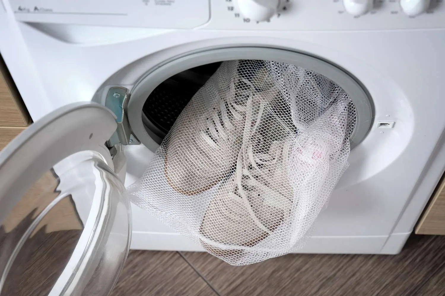 Top-loading and front-loading washing machines side by side in a utility room