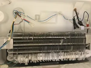 Upright freezer with clear vents and a thermometer showing cold temperature