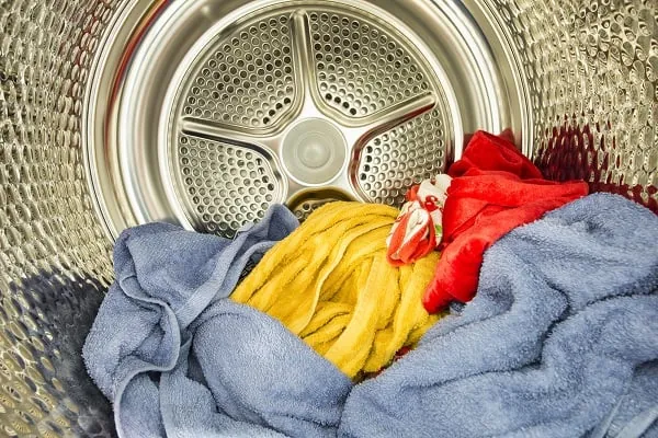 Wet tangled towels inside an open top-load washing machine drum
